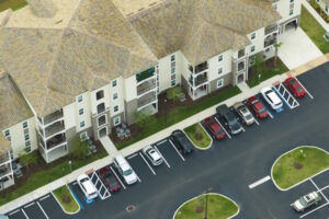 cars parked in front of a housing area
