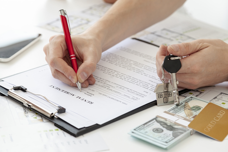 man signing rental contract